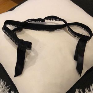 Lingerie item. Adjustable. Black. Not sure exactly what you do with it.